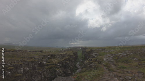 Obraz na płótnie Almannagja is an eight-kilometer-long gorge within Pingvellir National Park, which marks the edge of the North American plate and the beginning of the Þingvellir rift valley in Iceland. w salonie