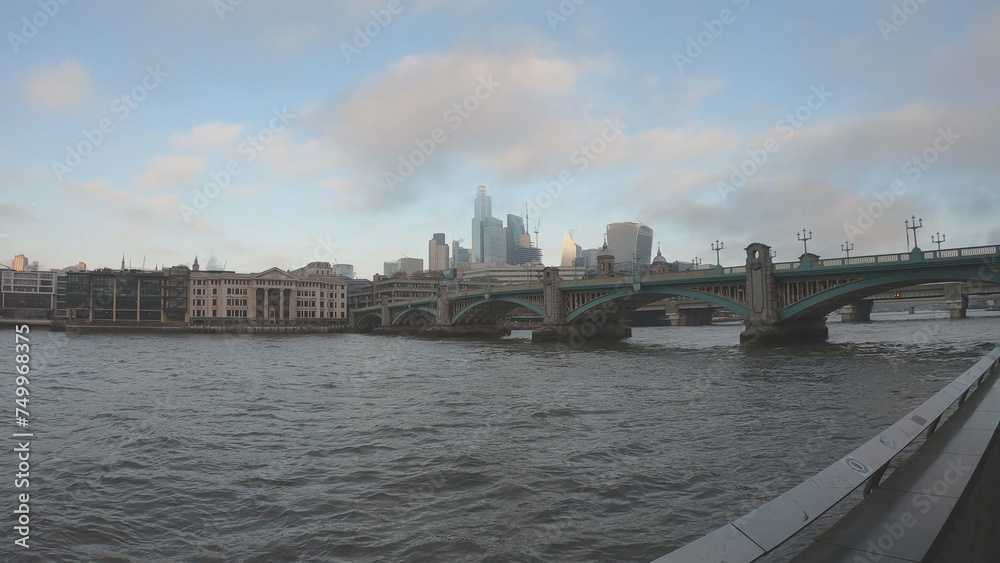 Boats on the River Thames with the Southwark Bridge and skyscrapers in the background, London, England, United Kingdom.