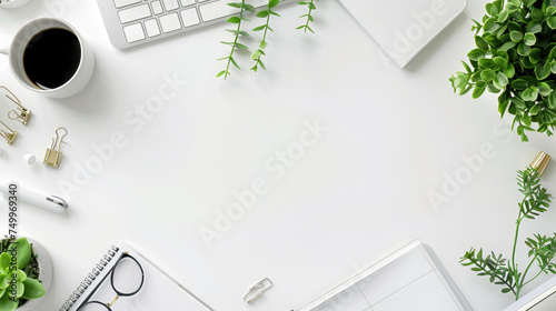 A tidy desk with office supplies, a cup of coffee, and a touch of greenery, showcasing a modern, minimalist work environment