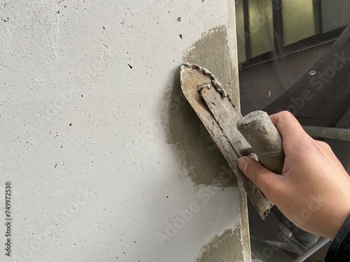 worker painting a wall with a brush photo