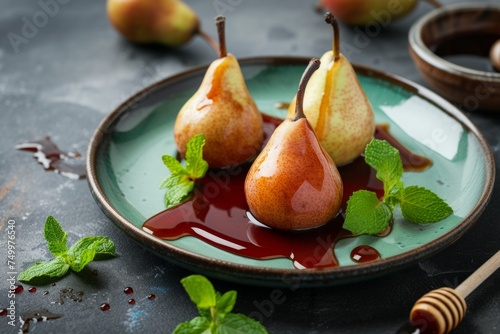 green plate of yellow pears in red wine with mint leaves and honey on grey table. French dessert, food photo