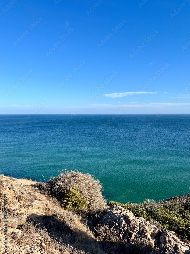 Blue ocean horizon, rocky coast, ocean bay Blue ocean horizon, rocky coast, ocean bay