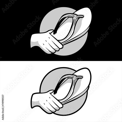 A hand holding a flip flop