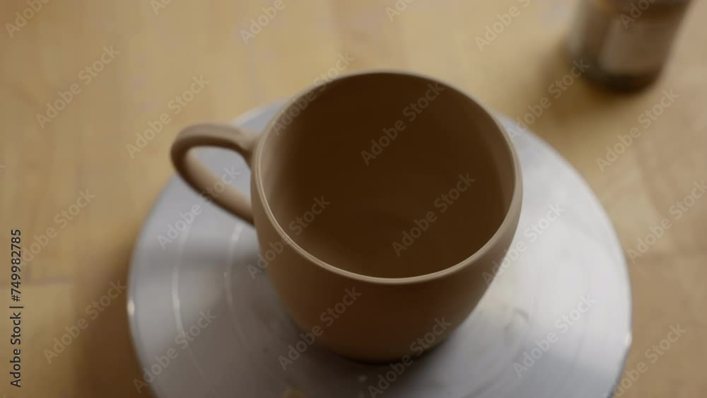 Earthenware Coffee Mug on Saucer with Soft Focus on a Wooden Table in a Homely Setting