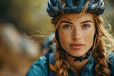 A portrait of a young woman with freckles wearing a blue cycling helmet and a focused expression
