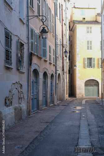 Romantic backstreet road alley in historic old town downtown Toulon  France with Mediterranean style house building facades and old little piazzas fountains picturesque city scenery