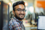 A Smiling Indian software engineer at work, IT specialist