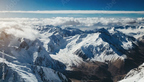 Beautiful snowy mountain peaks, blue sky with clouds