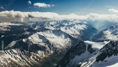 Beautiful snowy mountain peaks, blue sky with clouds