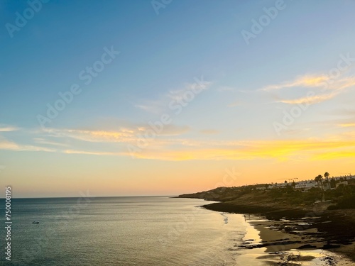 Orange sunset at the ocean  rocky ocean bay