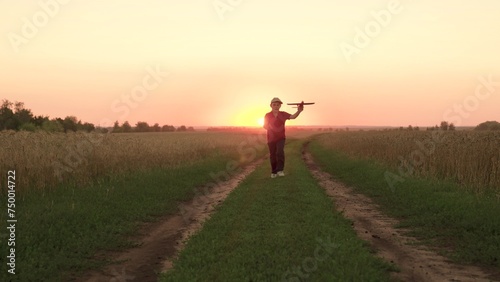 child kid baby boy runs across field with rainbow kite hands sunset, children's dream flying, airplane pilot, happy boy playing with flying kite park sunset, feeling freedom vacation, flying kite