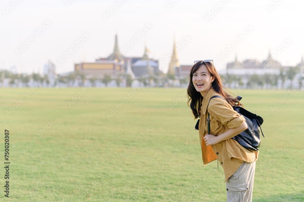 Traveler asian woman in her 30s explores the Grand Palace complex. This photo embodies the fascination with Thai culture and heritage.