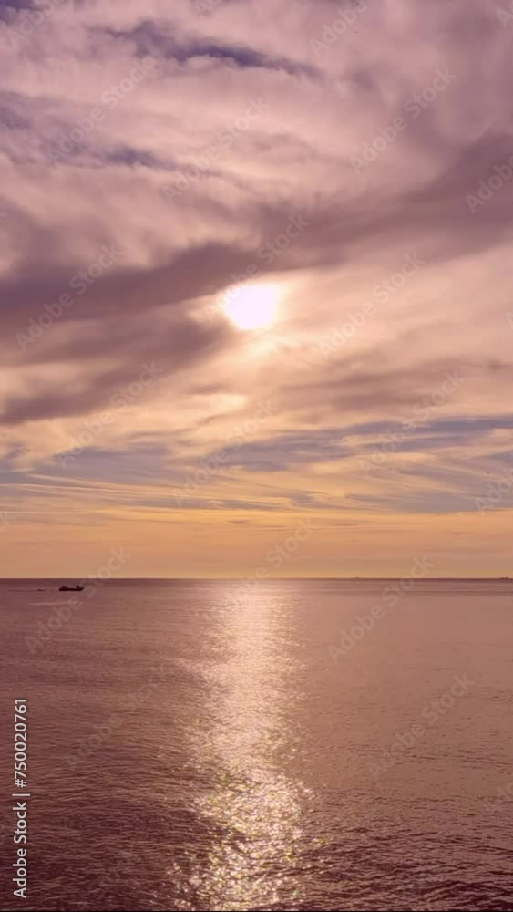 Time Lapse, Sunrise above bay in the Mediterranean Sea, Dark clouds flowing away, sun light beam through the cloud sending across the water's surface, Vertical video. Nature environment background Time Lapse, Sunrise above bay in the Mediterranean Sea, Dark clouds flowing away, sun light beam through the cloud sending across the water's surface, Vertical video. Nature environment background