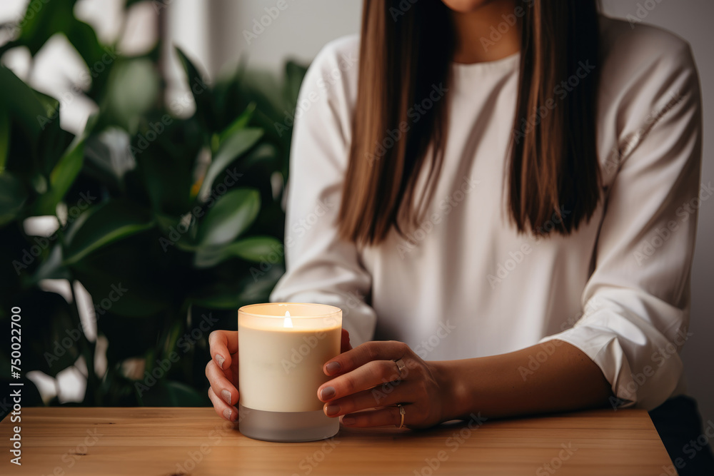 Young woman holding hand made candle. Small business concept Young woman holding hand made candle. Small business concept