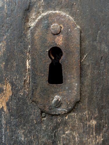 Close up of old keyhole on antique wooden door