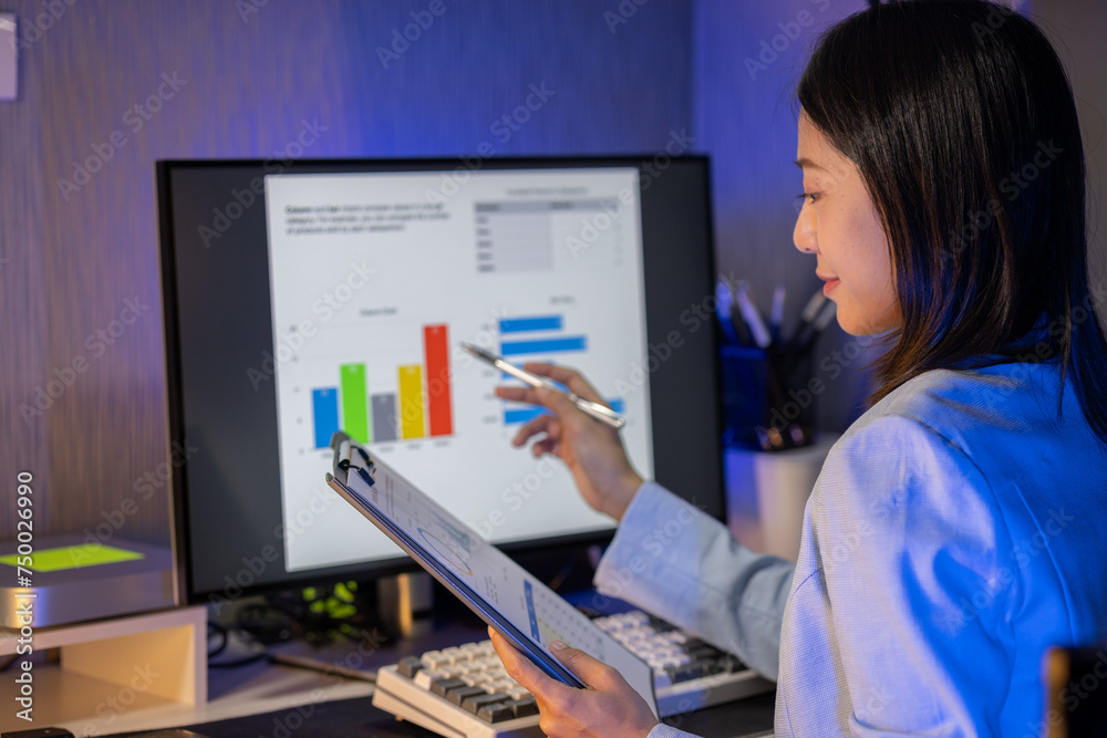 An employee is working on a detailed graph that shows results reporting various results about the company, Check the graph report before submitting it to the supervisor according to the work schedule. An employee is working on a detailed graph that shows results reporting various results about the company, Check the graph report before submitting it to the supervisor according to the work schedule.