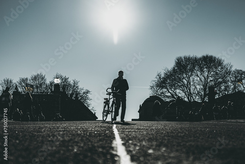 man with bicycle on the asphalt road in the city