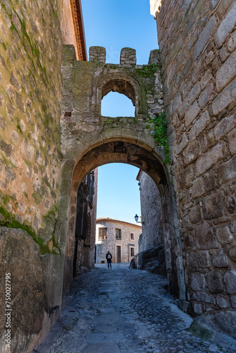 Narrow picturesque alley with stone arch and medieval architecture, Trujillo, Extremadura