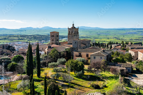 Fotografie Medieval churches and towers with mountainous landscape in the background in the