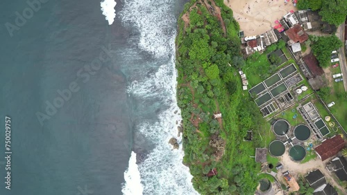 Aerial view of sea blue waves break on rock and sand. Beautiful of sea water wave come to beach with green trees. photo