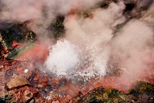 Vibrant geothermal spring with steam and colorful mineral deposits, showcasing nature's energy. Location: Deildartunguhver, the Largest Hot Springs in Europe.