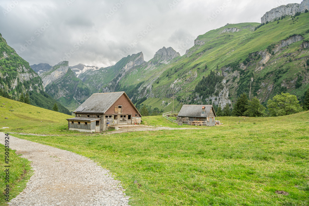 Hikinig trail towards Seealpsee, an alpine lake in Appenzell Alps in Switzerland. small mountain hut in the Swiss Alps. Beautiful hiking area. Appenzell mountains.