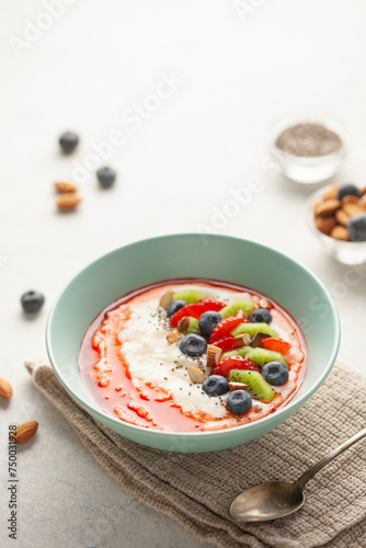 Sweet milky semolina porridge with fruit, berries and nuts in a bowl on the table. Healthy children's breakfast