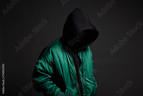 Stylish Man. Person in Black Hood and bomber jacket