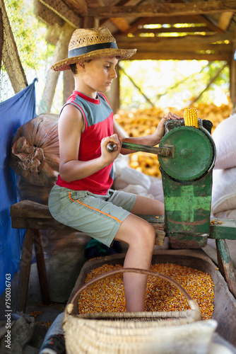 Boy processing corn