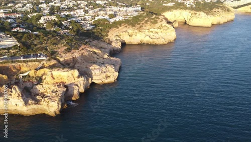 Aerial panorama of Carvoeiro reveals stunning rock formations and crystal-clear waters, highlighting Algarve's picturesque landscape.