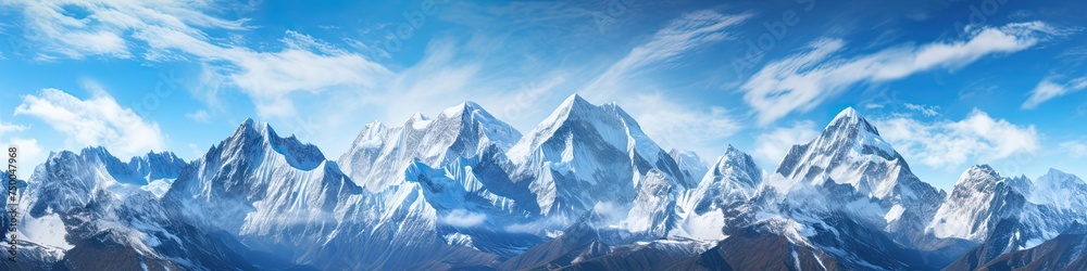 Snow-Capped Mountain Peaks in Panoramic View: The Majestic Mountaintops Bathed in Golden Sunlight
