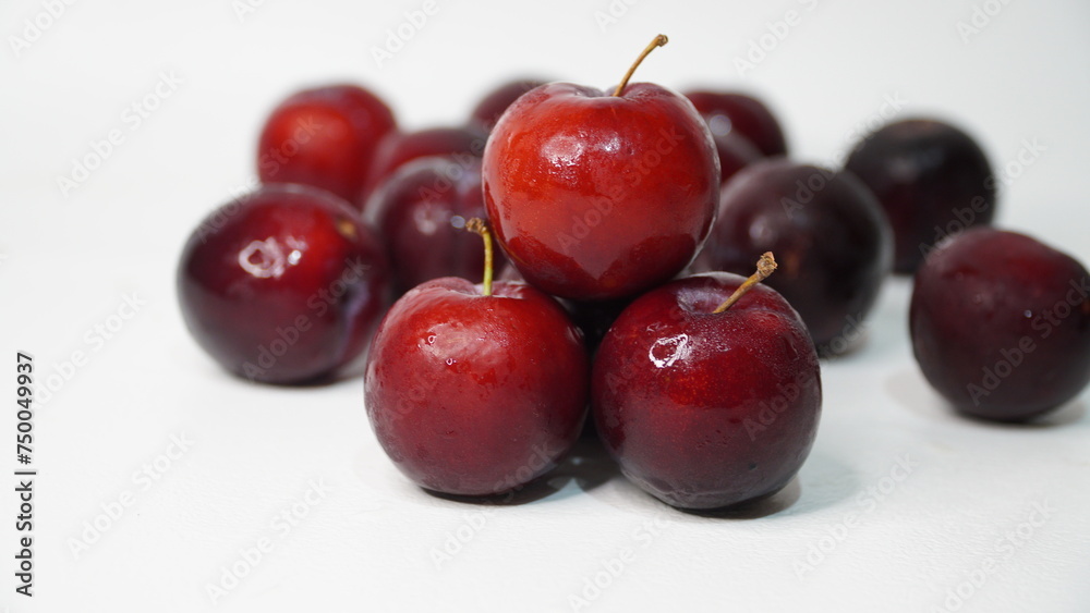 Fresh red plums isolated on a white background