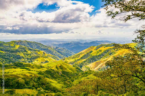 Verdant slopes of Monteverde under a dynamic sky, showcasing the rich biodiversity and layered mountain vistas of Puntarenas Province, Costa Rica. High quality photo.