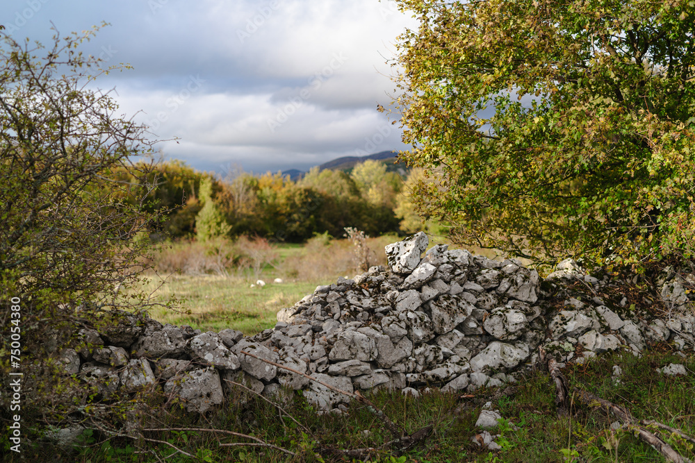 Landscape with stone wall in Croatian mountains.