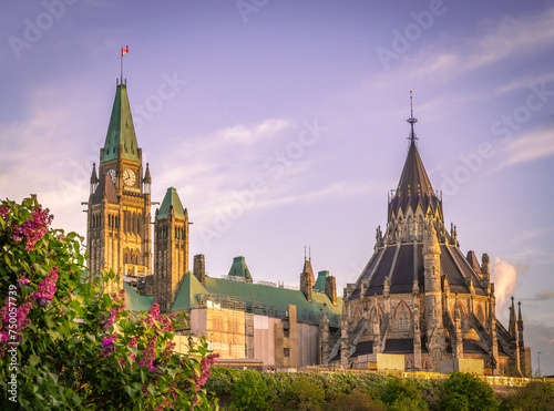 Parliament of Canada and Library of Parliament on hill, during spring with lilac flowers, Ottawa, Ontario, Canada. Photo taken in May 2022. photo