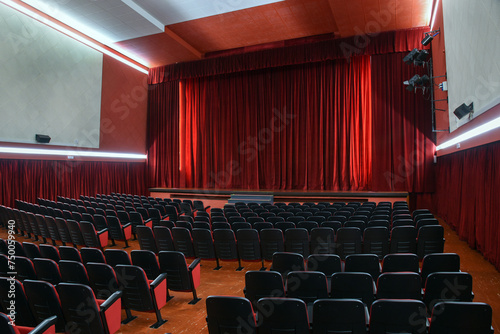Empty theatre with red curtains stage in lights