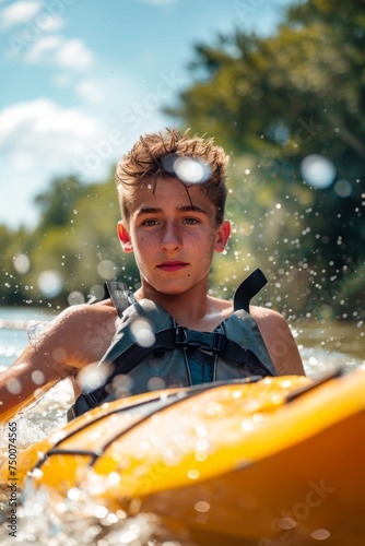 Young boy kayaking on a river © Oscar