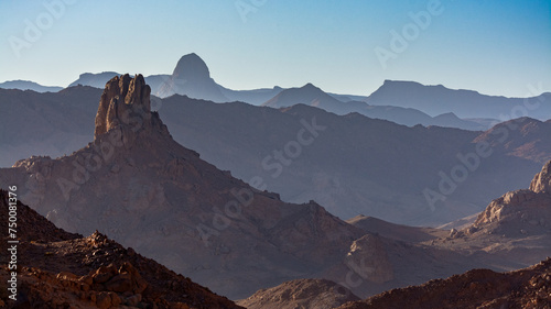 Hoggar landscape in the Sahara desert, Algeria. Steep peaks rise up in a mineral setting photo