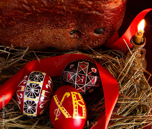 Easter. Easter symbols. Easter cake (paska), painted eggs, red ribbon. 