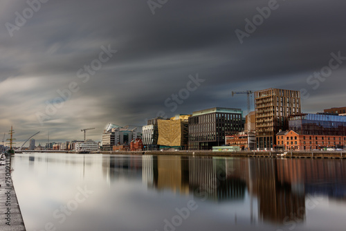 Photography Dublin, Ireland, Dockland, modern building business center cityscape by Liffey river view during sunny day with tall ship and Samuel Beckett bridge in background