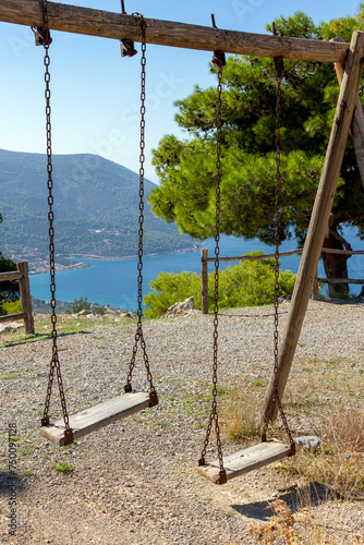 Wooden playground swings in a open air playground near Porto Germeno town, in western Attica region, near Athens, Greece. photo