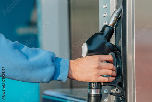 hand at the gas pump at the gas station
