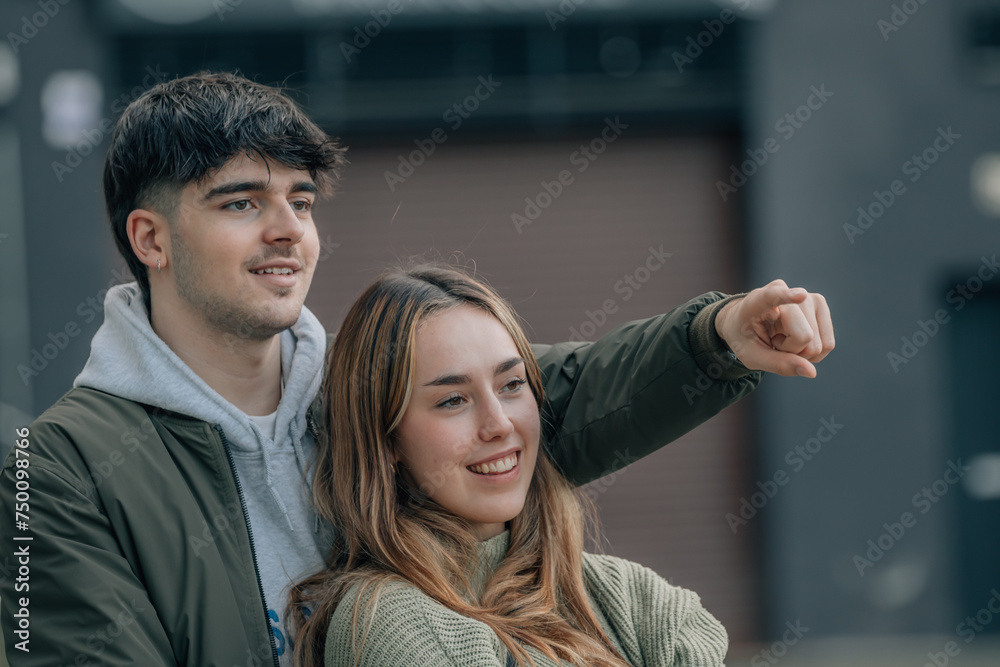urban young couple on the street pointing