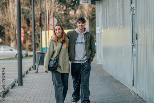 urban young couple on the street walking holding