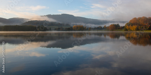 Lac d'Autun et collines avec la pierre de Couhard dans la brume en Bourgogne en automne