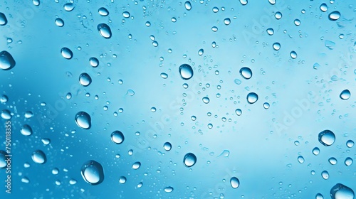 A fresh aesthetic is achieved with water drops glistening on a blue surface.