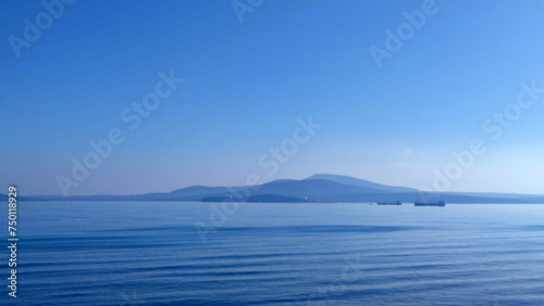 drifting barges in the Black Sea waters of Burgas Bulgaria, seascape in a blue haze