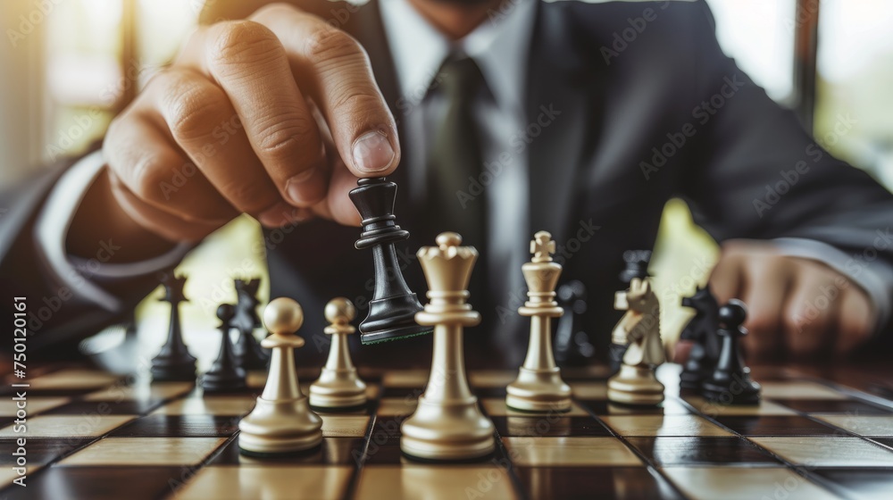 A man dressed in a suit concentrating on a game of chess - obrazy, fototapety, plakaty 