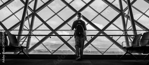 Travel, airport, woman waiting for a flight looking out the window, solo travel,faceless,airport transit area, travel experiences, authentic travel,bw, black and white, monochrome