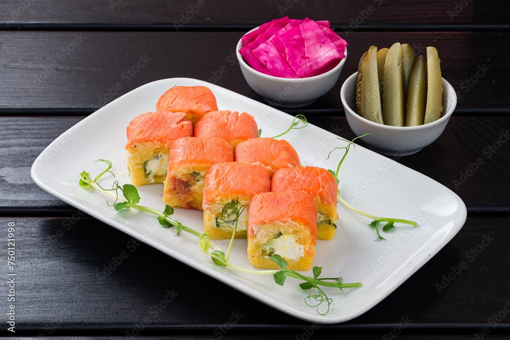 Lunch salad in the form of rolls from salmon, boiled potatoes, cucumber, cream cheese with pickled cucumbers and cabbage. Lunch salad in the form of rolls from salmon, boiled potatoes, cucumber, cream cheese with pickled cucumbers and cabbage.